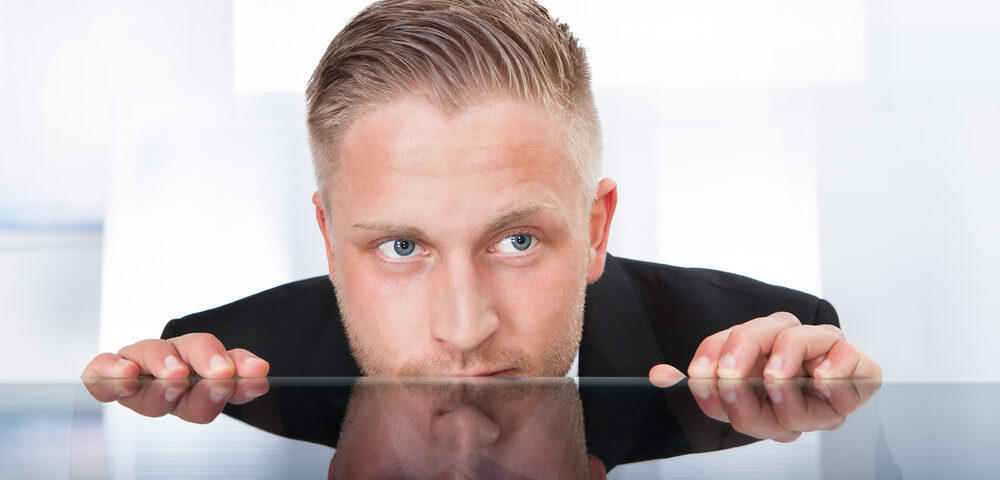 man looking over table