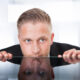 man looking over table