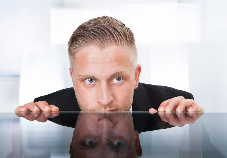 man looking over table