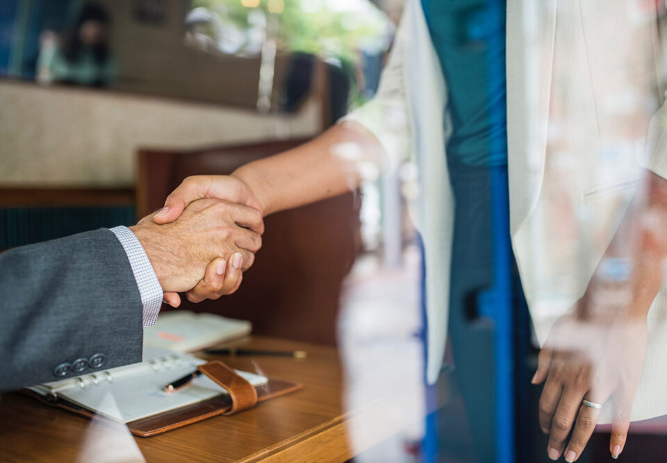 person shaking hands with attorney