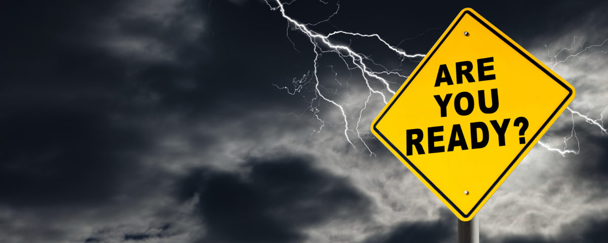 "Are You Ready" road sign against a dark, stormy sky with lightening streaking