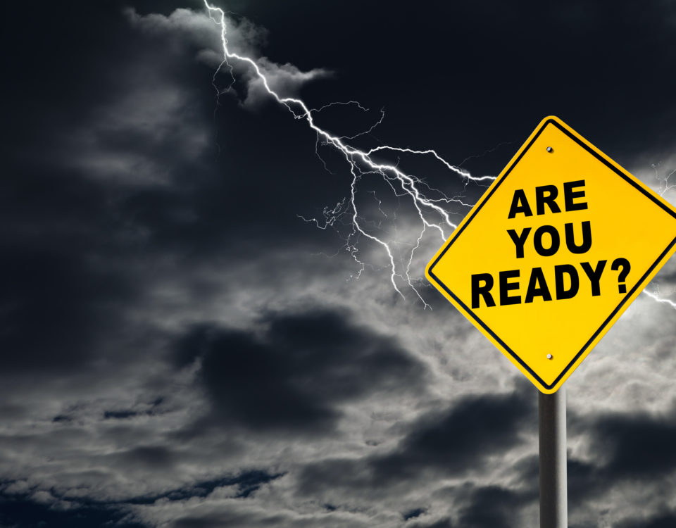 "Are You Ready" road sign against a dark, stormy sky with lightening streaking